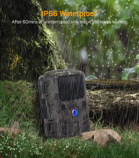 Camouflage trail camera standing outdoors in heavy rain and forest grass with visible IP66 waterproof protection text