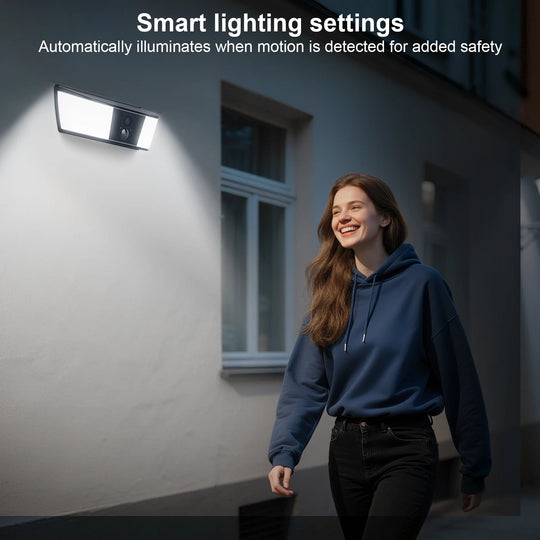 GPS outdoor wall light with built in camera illuminates a woman walking past a house, illustrating automatic motion activated lighting for added safety