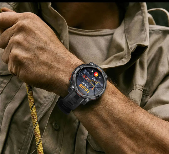 GPS tactical smartwatch worn on a mans wrist during an outdoor adventure, with a rugged black case and colorful digital display