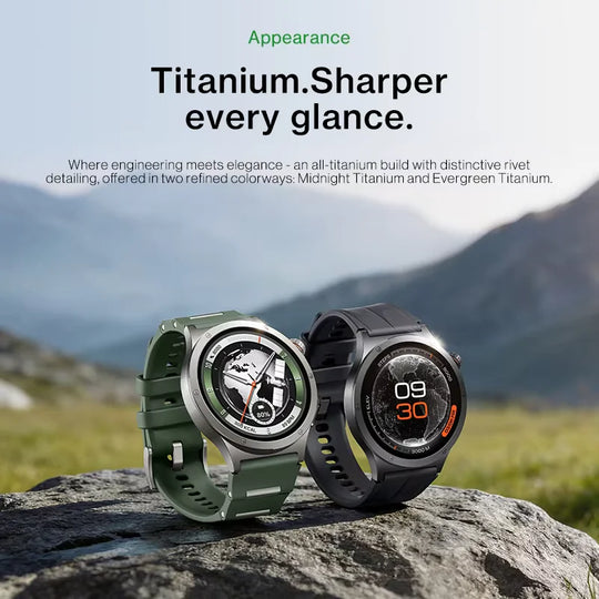 Two titanium smartwatches with green and black straps displayed on a rock against a mountain landscape, highlighting their rugged design and clear watch faces